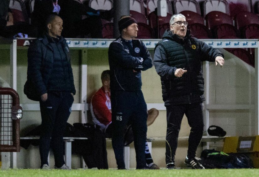 Ian McCall gives his side instructions from the dugout.