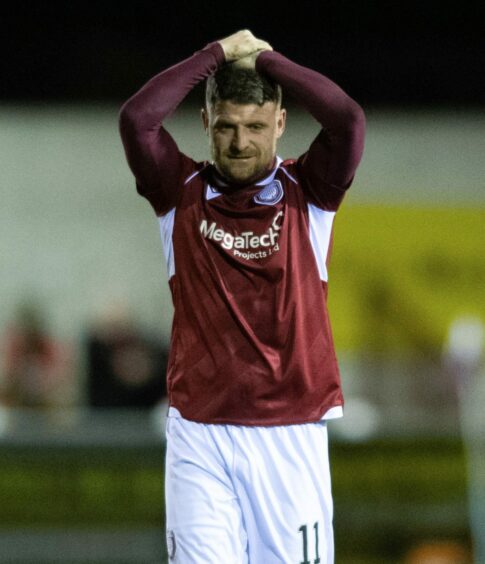 Bobby Linn reacts after seeing his free-kick hit the Partick Thistle post.