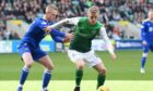 St. Johnstone's Cammy MacPherson gets to grips with Hibernian's Ewan Henderson.