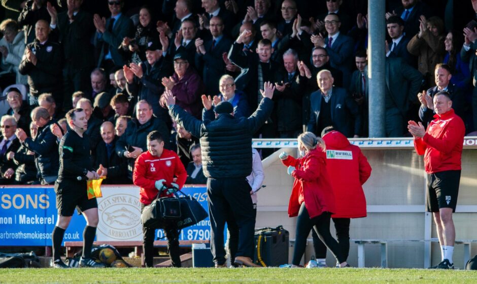 Arbroath boss Dick Campbell delebrates with fans at full-time.
