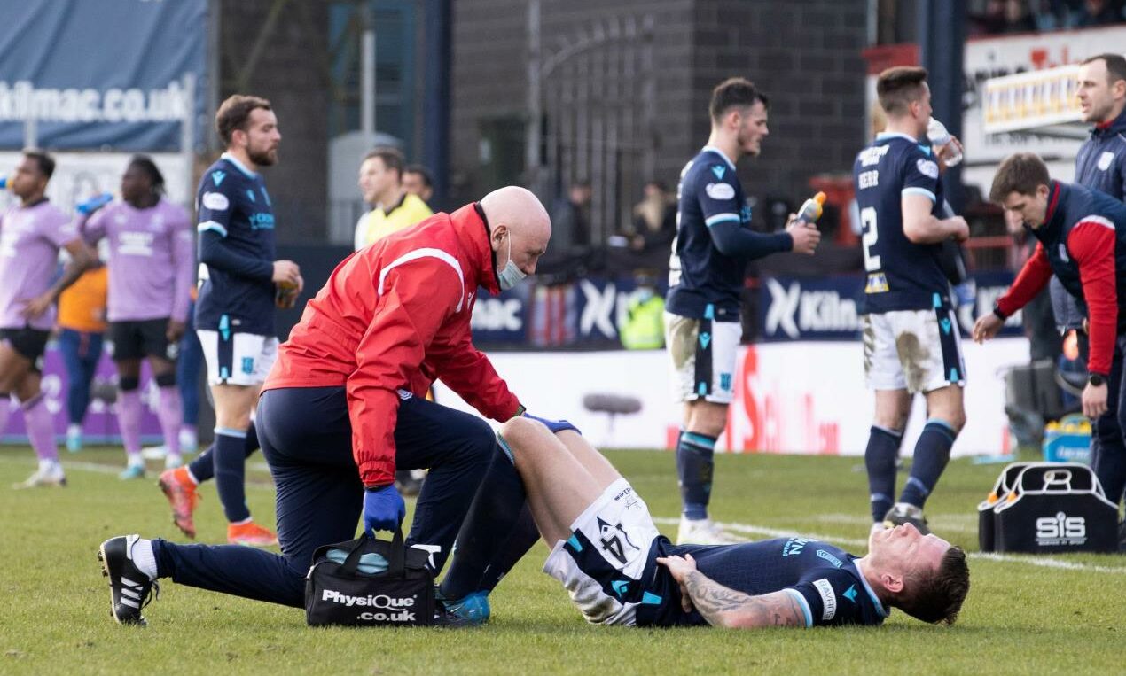 Former Dee physio Gerry Docherty tends to Ashcroft after he suffered his last injury.