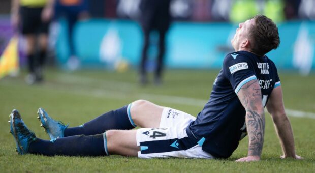 Dundee's Lee Ashcroft goes down injured against Rangers.