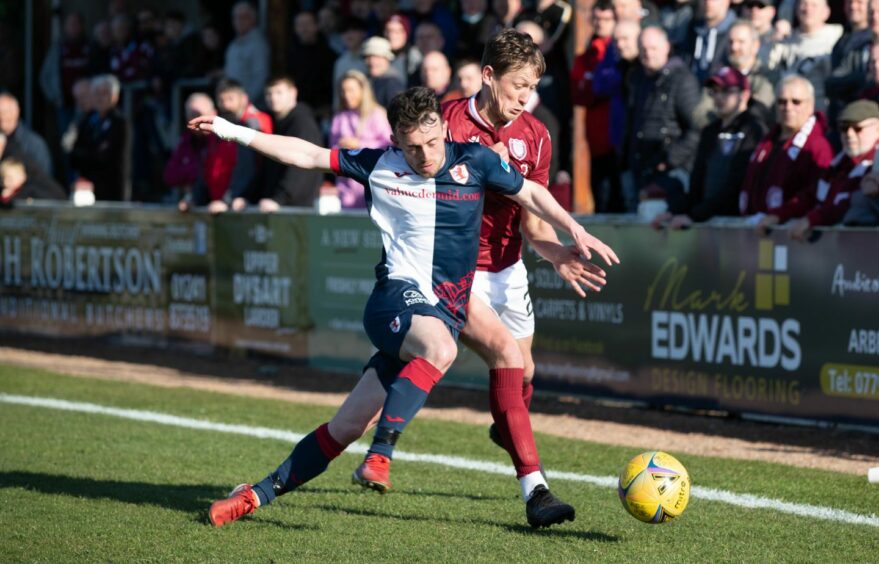 James Craigen and Aidan Connolly tussle for the ball.