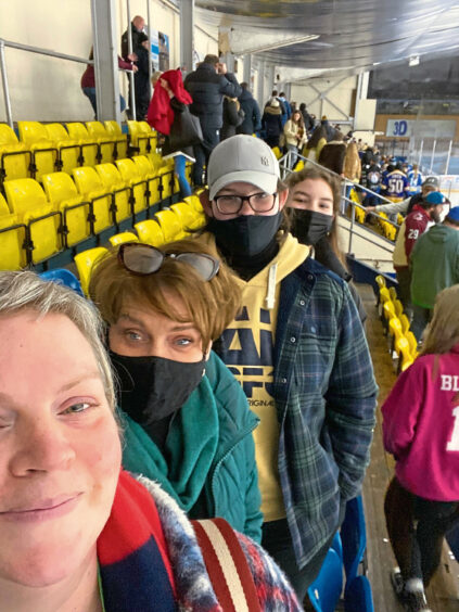 Mary Jane Duncan and her family at an ice hockey game.