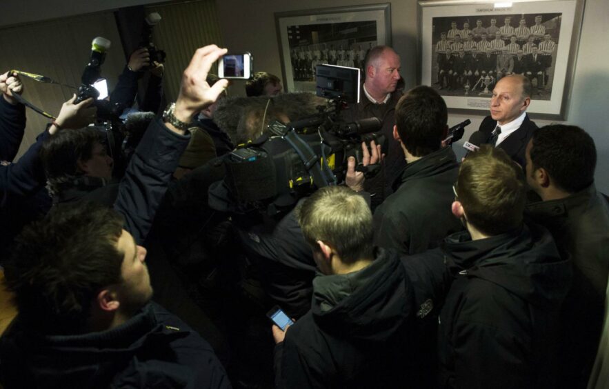 A media scrum surrounds administrator Bryan Jackson following Dunfermline's descent into administration.
