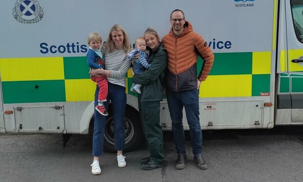The Clayton family, including baby Fraser, with call handler Lorna Milward.