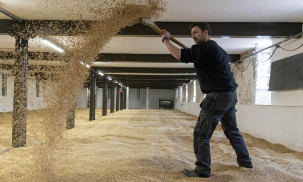 Maltings operator, Nicol Roberston using using traditional methods to turn the malt at Glen Garioch's Oldmeldrum Distillery in Scotland as it reopens to the public for the first time in two years following a £6 million investment from its owner, Beam Suntory. The distillery, one of the oldest still operating in Scotland, is returning traditional production processes and is aiming to reduce its carbon footprint following the investment. Glen Garioch is also introducing a 'Bottle Your Own' cask experience at the distillery, with the launch of the 1991 Bourbon Single Cask. Picture by PA.