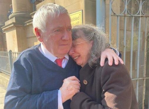 Dennis Campbell comforts his wife Avril outside Dundee Sheriff Court after their acquittal