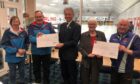 Marianne Jenkins and Ian Taylor (Forfar Young Curlers), Evenie Water patron Evan Bruce Gardyne, Kay Gibb (Scottish Curling Trust) and Evenie Water president Alan Arnot.
