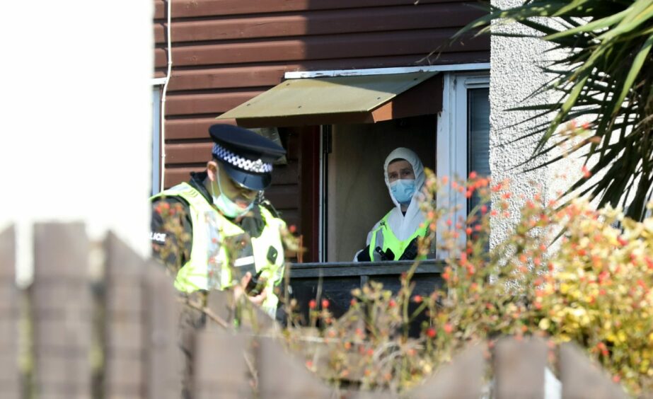 Police and foresnics officers at a house in Whitfield, Dundee