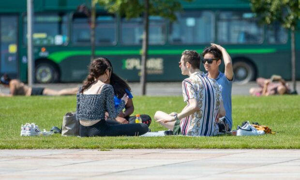 Locals enjoying sunshine at Slessor Gardens in Dundee.