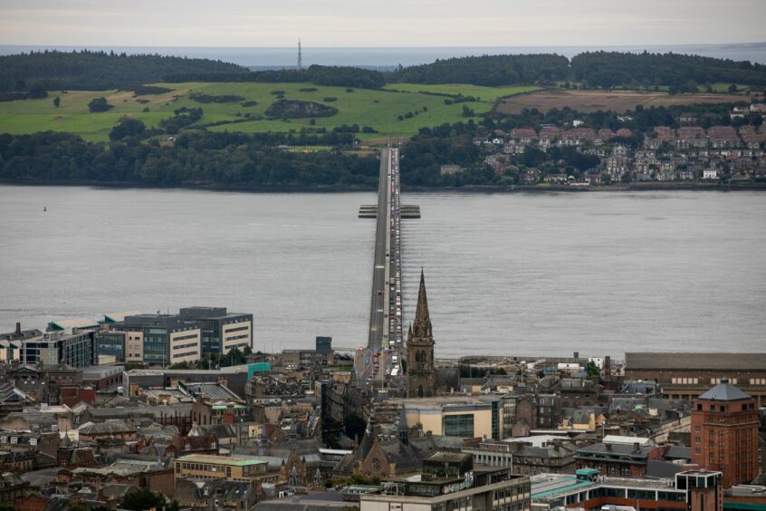 Photo shows a view of Dundee looking across the city to the River Tay and the Tay Bridge leading to Fife. 