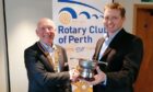 Mike Robinson (right) receives the Cairncross Award from Perth Rotary president Joe Cairns