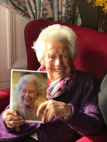 Olive walker with her card from the Queen