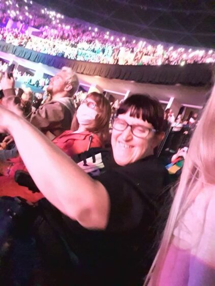 Shown enjoying the JLS concert she attended is Petra Ryce, smiling.