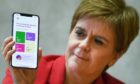 First Minister Nicola Sturgeon pictured with the track and trace app