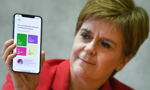 First Minister Nicola Sturgeon pictured with the track and trace app