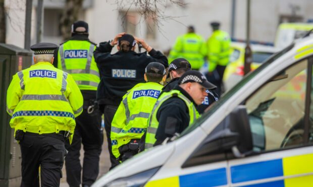 Police and specialist officers at Hilltown terrace on Sunday.