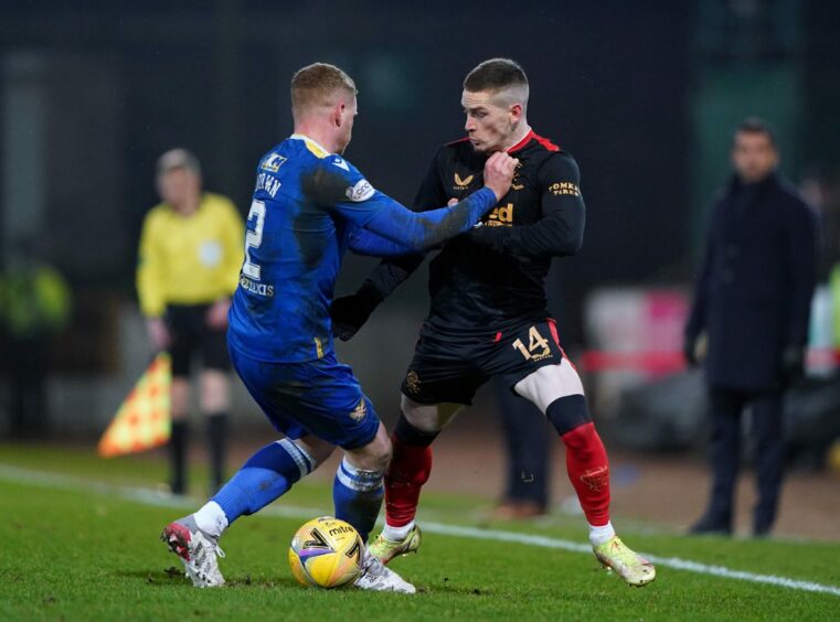 St Johnstone player James Brown gets to grips with Ryan Kent.