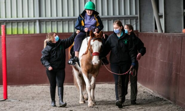 Millis Thomson marked her 100th birthday by getting on Django at The Brae RDA centre. Picture: Steve Brown.