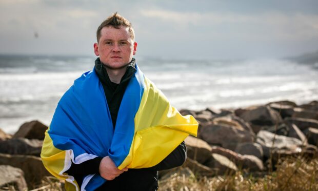 Serhii Melnychenko, 25, showing support for his family in Ukraine.