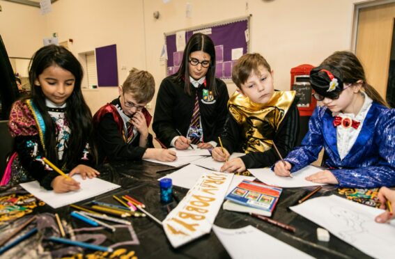 World Book Day magic at Tayview Primary School with (from left) Maies Alshomrani, Lucas Easton, Miss Kidd, Jude Monaghan and Paige Brown. Pictures by Steve Brown / DCT Media.