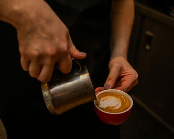 Pouring a coffee with latte art.