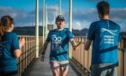 Euan Smith hands over the baton to the next runner at the 24-hour Tay Bridge relay.