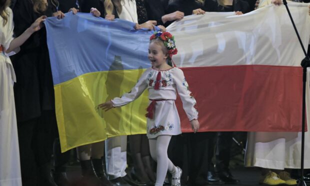 Amelia Anisovych,7, from Ukraine on stage during the charity concert 'Together with Ukraine'  in Lodz, central Poland.