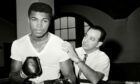 Young heavyweight fighter Cassius Clay is seen with his trainer Angelo Dundee at City Parks Gym, New York. Picture: Shutterstock.