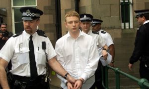 Robbie McIntosh is led away by police following his conviction at the High Court in Forfar in 2002.