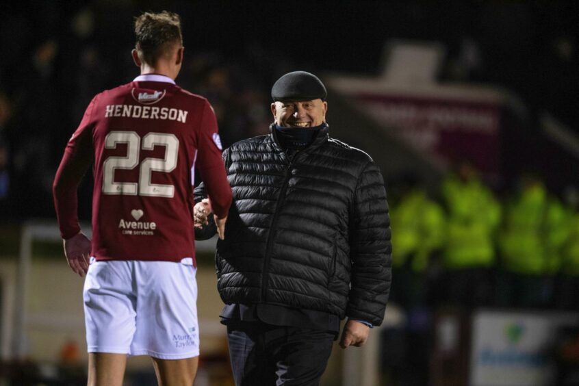 Liam Henderson is congratulated by boss Dick Campbell earlier in the season.
