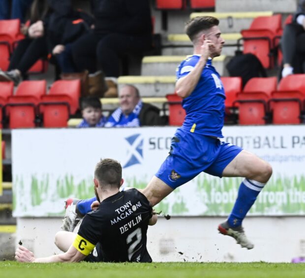 Tony Gallacher is tackled by Livingston's Nicky Devlin which leads to his injury.