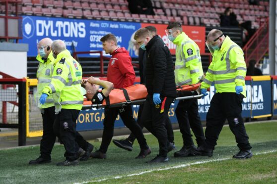 Arbroath midfielder Chris Hamilton is stretchered off in the first half.