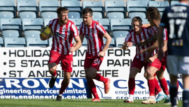 Shaun Rooney celebrates his equaliser.