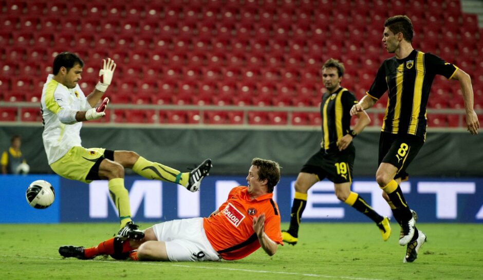 Daly slides home the leveller against AEK Athens in Greece