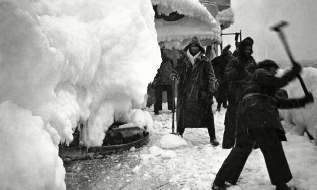 Thick ice and snow on the deck of H.M.S. Vansittart while on convoy escort duty in the Arctic during the Second World War