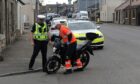 Police assisting in the recovery of the motorcyclist's bike following the collision on Main Street, Thornton.