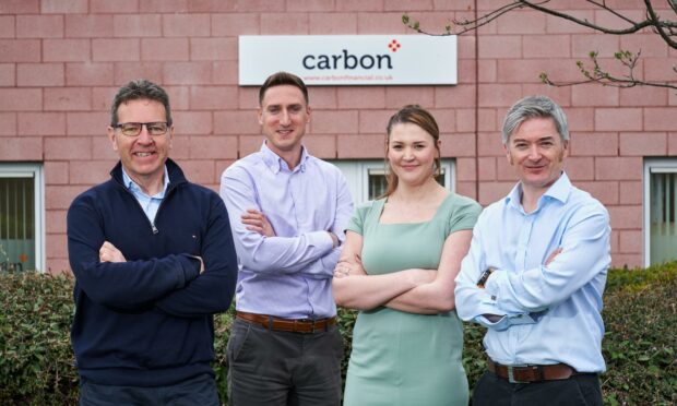 Carbon Financial partners directors Gordon Wilson and Mark Christie flank financial advisors Zoe Malpas and Michael Wilson at their new Perth offices..