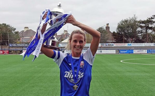 Lisa Anderson of Montrose FC women holds aloft the SWF Championship North trophy