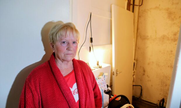 Catherine Stewart, 70, shows mould in her council home.