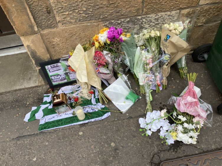Floral tributes left outside the home of Ian Menzies.