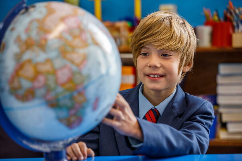 Child with globe at school