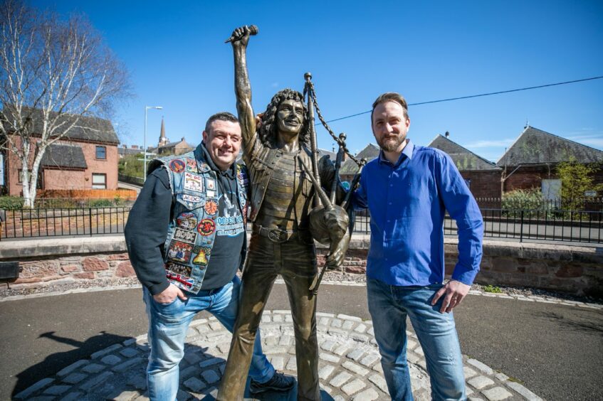 Bonfest chairman John Crawford and DD8 Music manager Scott Ferguson at the Bon Scott statue on Bellies Brae. Image: Kim Cessford/DC Thomson.