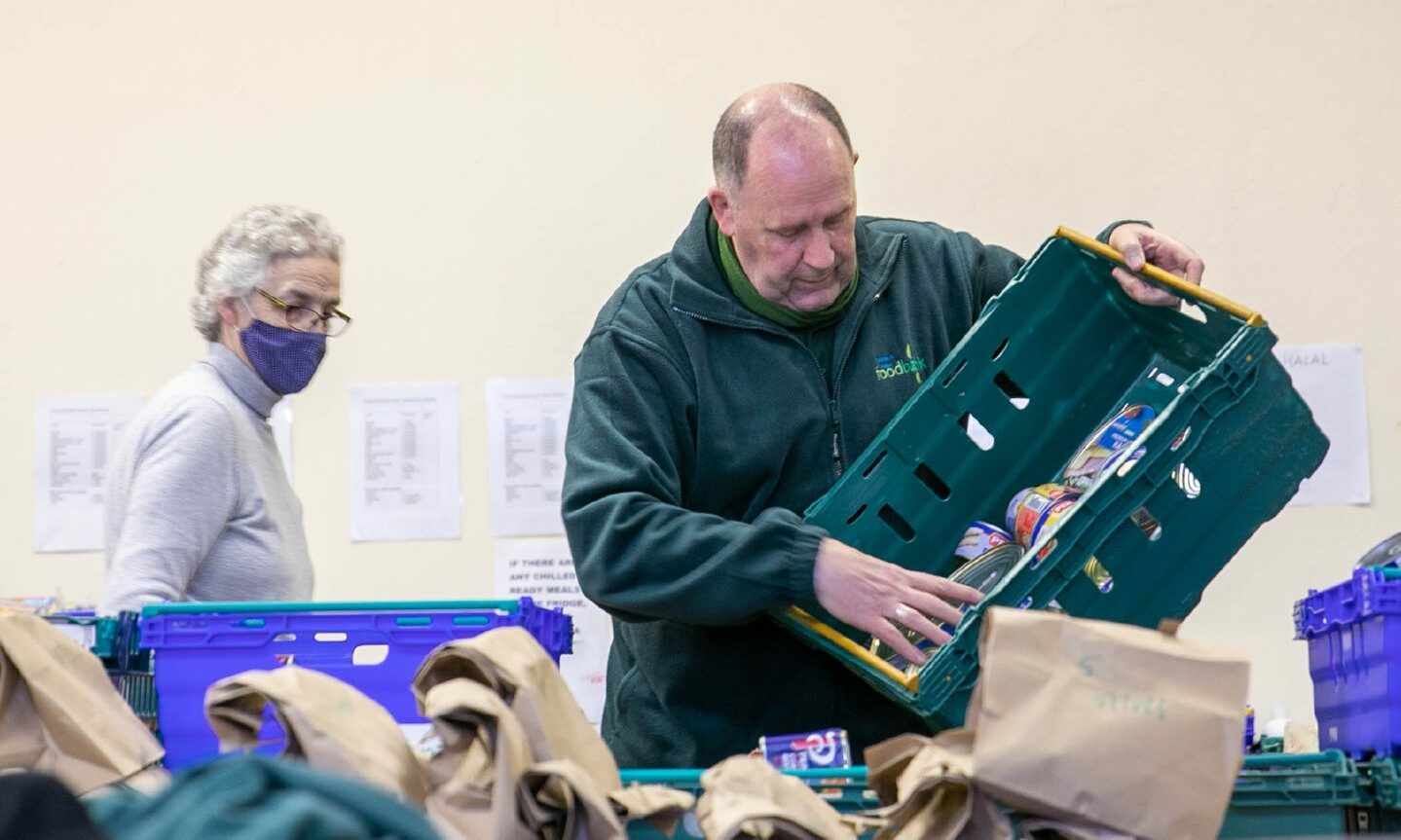 Dundee and Angus Foodbank manager Ken Linton and volunteers organise donated food into parcels.
