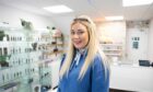 Vape shop manager Dawn Squires shows off her maskless smile.