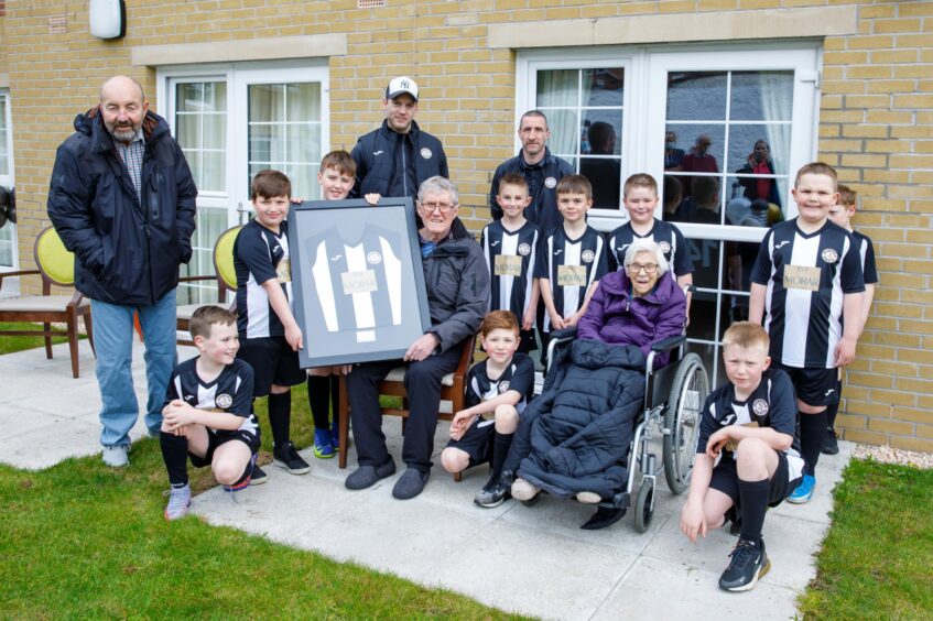 Players from junior football team, Jeanfield Swifts 2013, with some residents from Kincairney House Care Home.