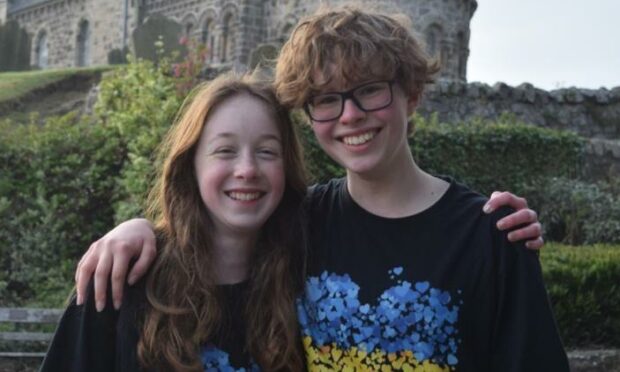 Lucy, left, and Ash complete their 43-mile trek in Leuchars.