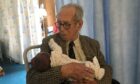 Henry Topping holding his great-grandson.