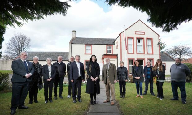Minister for environment and land reform Mairi Mcallan, centre, with MSP David Torrance, left, and John Hamilton, right and representatives of some of the groups who use the club.